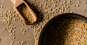 grains of quinoa with a wooden scoop spoon